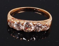 Lot 1287 - An 18ct gold and diamond five stone ring, the...