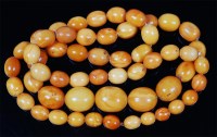 Lot 1215 - A beaded butterscotch and egg-yolk amber...