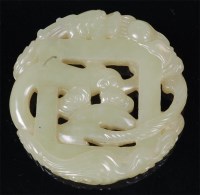 Lot 1379 - A Chinese carved green jade amulet, carved...