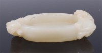 Lot 1401 - A Chinese carved celadon jade shallow dish, of...