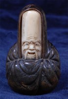 Lot 1408 - A Japanese carved ivory and horn netsuke of...