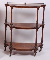 Lot 1549 - A Victorian figured walnut three tier whatnot,...