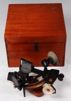 Lot 215 - A mid-20th century black lacquered and brass...