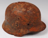 Lot 226 - A German model 1935 steel helmet with remains...