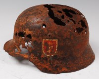 Lot 227 - A German 1935 model steel helmet with remains...