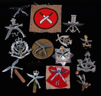 Lot 310 - A collection of assorted cap badges, cloth...