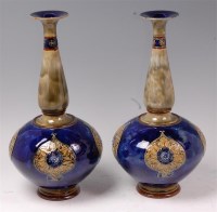 Lot 53 - A large pair of Royal Doulton stoneware bottle...