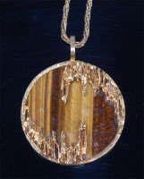 Lot 128 - A Kutchinsky 18ct gold and tigers eye pendant,...