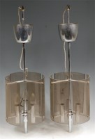 Lot 170 - A pair of 1960s chrome and smoky glass three...