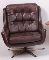Lot 334 - A 1960s Danish chocolate brown leather button...