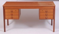Lot 370 - A 1970s Danish teak kneehole writing desk,...