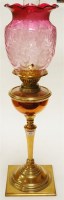 Lot 43 - A Victorian oil lamp, having etched cranberry...