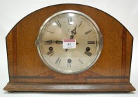 Lot 51 - An Art Deco oak cased mantel clock, having...