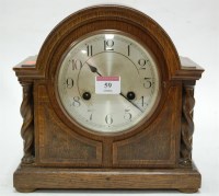 Lot 59 - A 1920s oak cased mantel clock, having...