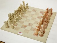 Lot 72 - A set of carved soapstone chess pieces on...