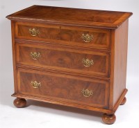 Lot 1141 - A figured walnut and oak chest, in the late...