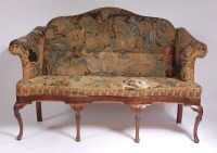 Lot 1148 - A walnut framed camel-back settee, in the...