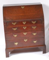 Lot 1183 - An early George III oak writing bureau, of...