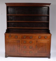 Lot 1191 - A George III oak dresser, the upper section...