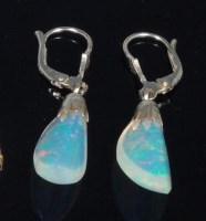 Lot 832 - A pair of polished and faceted opal ear...