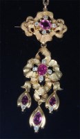 Lot 850 - A yellow metal, pink sapphire and diamond set...