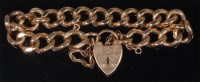 Lot 853 - A heavy 9ct gold curblink bracelet with heart...