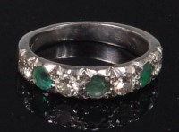Lot 861 - An 18ct white gold, emerald and diamond half...