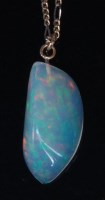 Lot 883 - A large polished opal pendant, the three-sided...