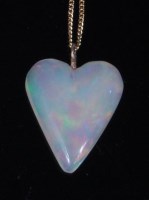 Lot 885 - An opal pendant, the polished heart shaped...