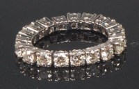 Lot 898 - A white metal and diamond eternity ring,...