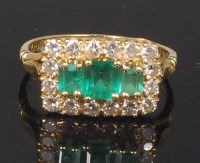 Lot 900 - An 18ct gold, emerald and diamond dress ring,...