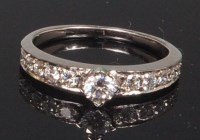 Lot 901 - A white metal and diamond dress ring, arranged...