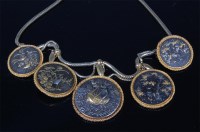 Lot 1032 - A Japanese Meiji period shakudo medallion set...