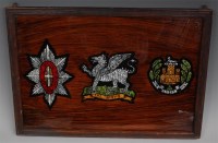 Lot 293 - A faux rosewood and oak framed regimental plaque.