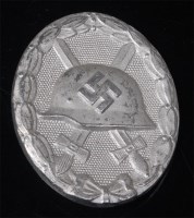 Lot 397 - A German Wound badge in silver, numbered verso...