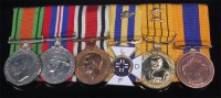 Lot 414 - A group of six medals to include WW II Defence...