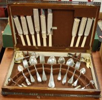 Lot 245 - A 1920s oak cased canteen of silver plated...