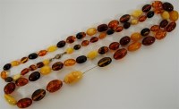 Lot 297 - A beaded amber necklace, the oval beads to...
