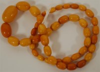 Lot 287 - A graduated and beaded butterscotch amber...