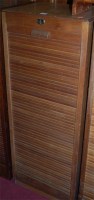 Lot 1092 - A 1930s light oak tambour fronted office...