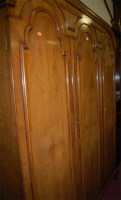 Lot 1104 - A walnut and figured walnut triple wardrobe by...
