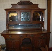 Lot 1105 - An Arts & Crafts carved oak mirror back...