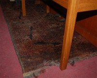 Lot 1127 - A Persian woollen red ground rug, the floral...