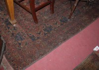 Lot 1128 - A Persian woollen brown ground rug, the floral...