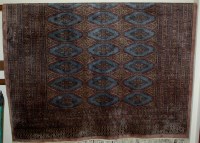 Lot 1129 - A Persian machine woven woollen bokhara rug...