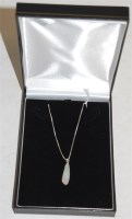 Lot 320 - A polished opal pendant on finelink neck chain