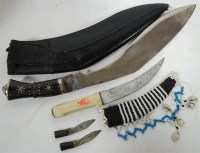 Lot 339 - An Eastern kukri in leather scabbard; together...
