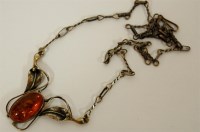 Lot 300 - An Arts & Crafts silver and amber set pendant...