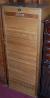 Lot 1090 - A 1930s light oak tambour fronted office...