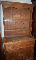 Lot 1137 - A modern stained pine kitchen dresser of...
